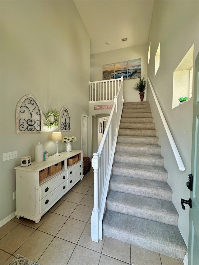 9808 Riverchase Dr, New Port Richey, FL 34655 - stairs featuring tile patterned floors and baseboards