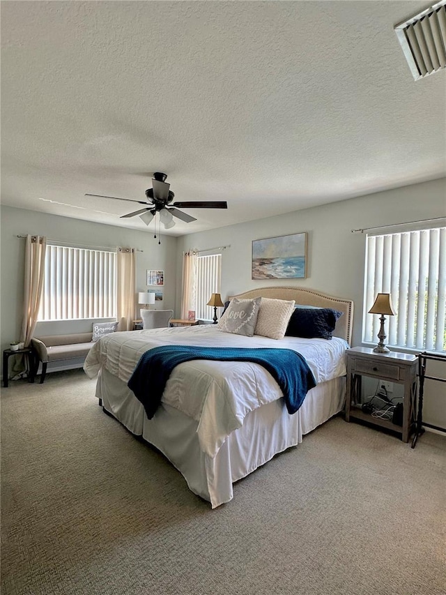 9808 Riverchase Dr, New Port Richey, FL 34655 - bedroom with carpet flooring, a textured ceiling, and a ceiling fan