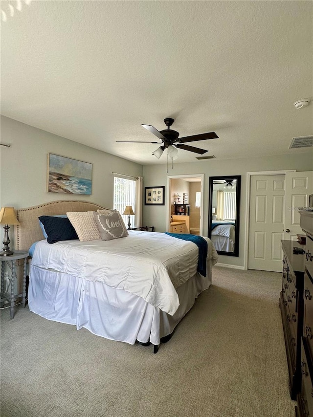 9808 Riverchase Dr, New Port Richey, FL 34655 - bedroom featuring a textured ceiling, carpet flooring, and a ceiling fan