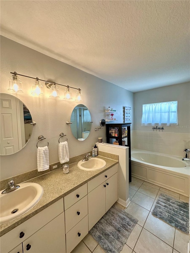 9808 Riverchase Dr, New Port Richey, FL 34655 - bathroom featuring a textured ceiling, tile patterned floors, double vanity, and a garden tub