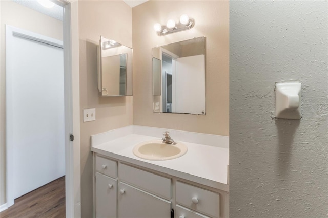 bathroom featuring vanity and wood finished floors