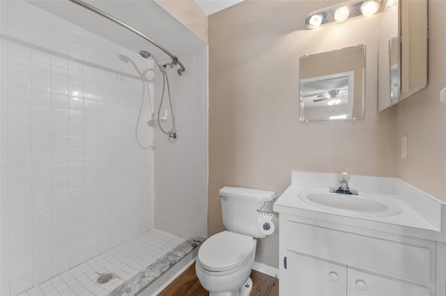full bathroom featuring a stall shower, vanity, and toilet