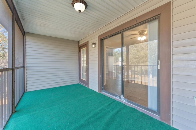 unfurnished sunroom with a ceiling fan