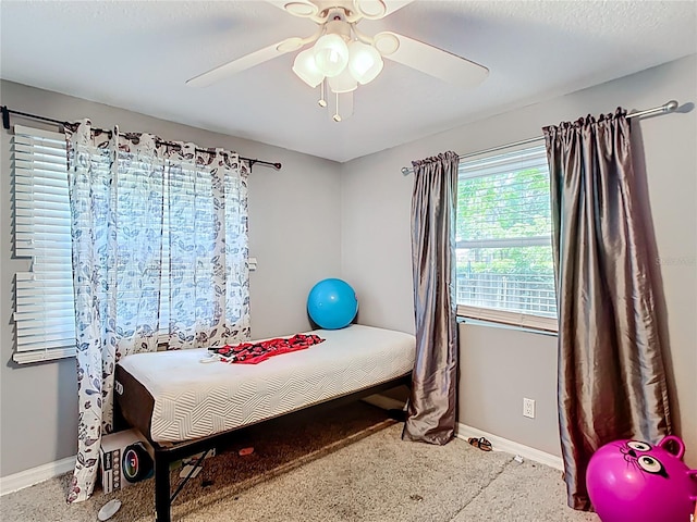 bedroom with baseboards and a ceiling fan