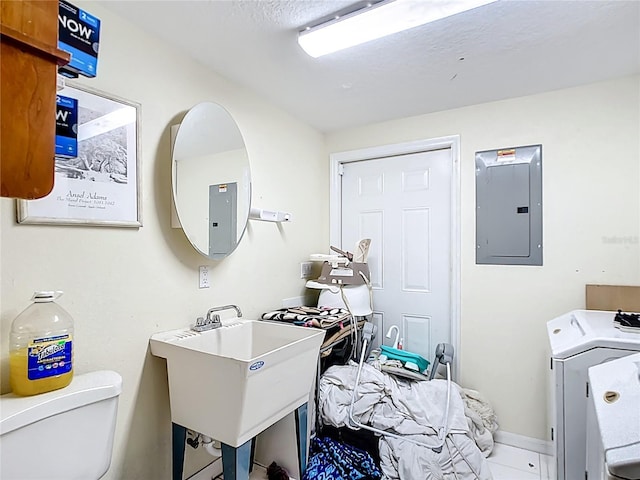 washroom with electric panel and washer / dryer