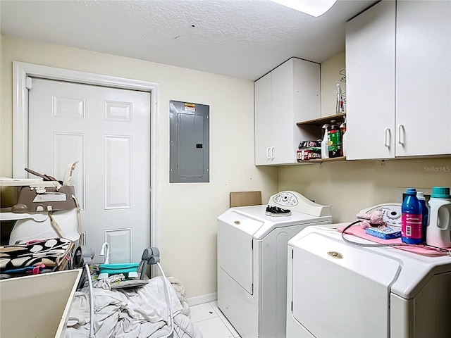 washroom with cabinet space, independent washer and dryer, electric panel, light tile patterned floors, and a textured ceiling