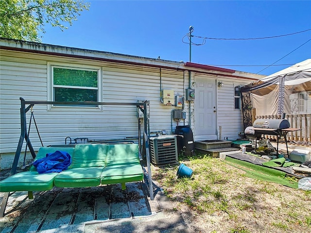 rear view of house with central AC unit