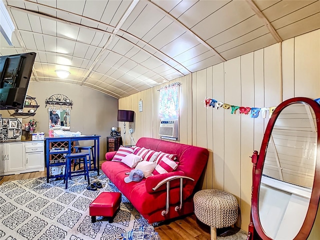 living area featuring wood finished floors and vaulted ceiling