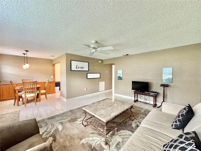 11619 Boynton Ln, New Port Richey, FL 34654 - living area featuring a ceiling fan, a textured ceiling, and light tile patterned flooring