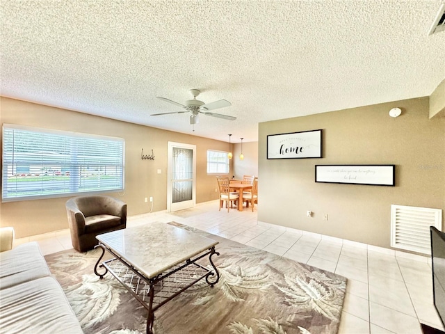 11619 Boynton Ln, New Port Richey, FL 34654 - tiled living area featuring a ceiling fan and a textured ceiling