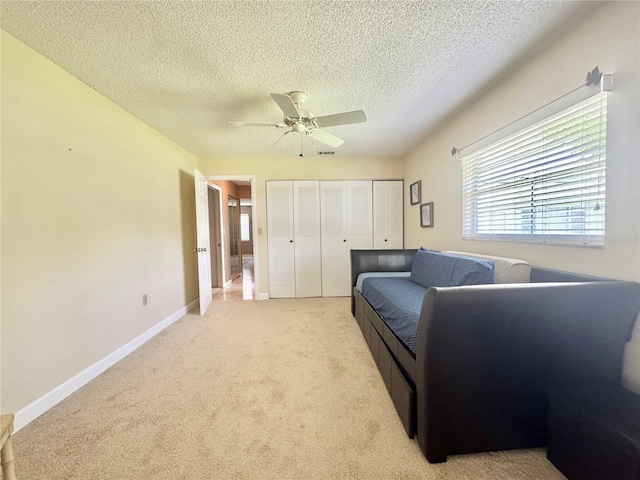 11619 Boynton Ln, New Port Richey, FL 34654 - living area with ceiling fan, light carpet, a textured ceiling, and baseboards