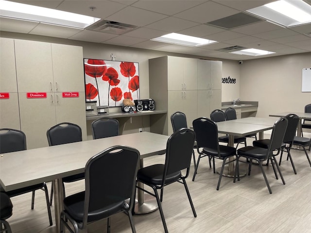 11619 Boynton Ln, New Port Richey, FL 34654 - dining room featuring light wood-type flooring and a drop ceiling