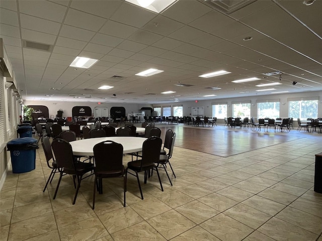 11619 Boynton Ln, New Port Richey, FL 34654 - dining space with a drop ceiling, healthy amount of natural light, and light tile patterned floors