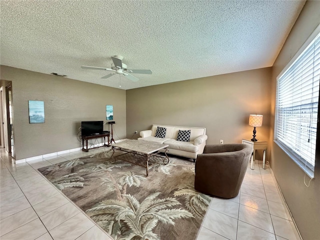 11619 Boynton Ln, New Port Richey, FL 34654 - living area with a ceiling fan, light tile patterned flooring, a textured ceiling, and baseboards
