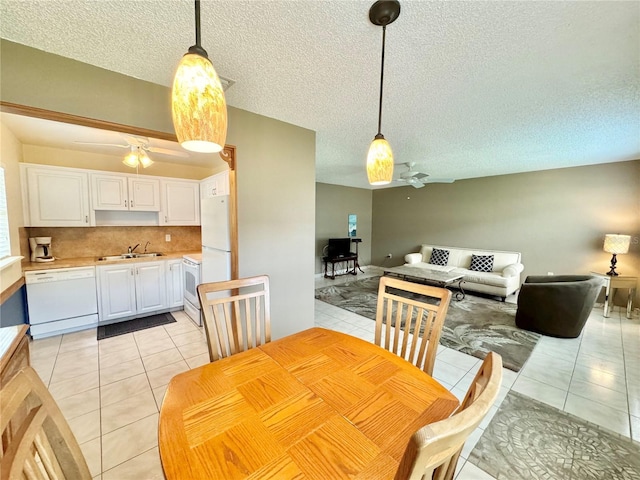 11619 Boynton Ln, New Port Richey, FL 34654 - dining space with ceiling fan, light tile patterned floors, and a textured ceiling