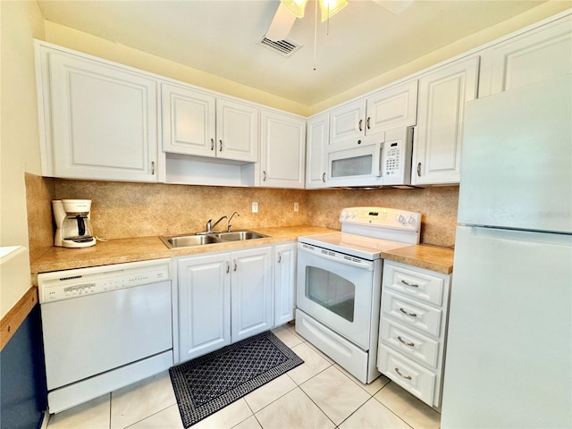 11619 Boynton Ln, New Port Richey, FL 34654 - kitchen featuring white appliances, a sink, white cabinetry, tasteful backsplash, and light tile patterned floors
