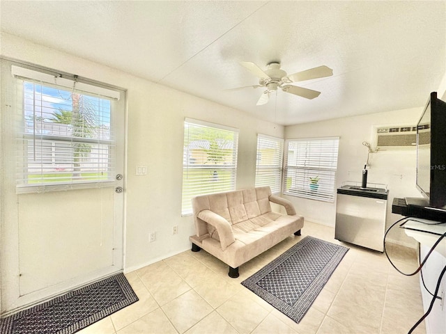 11619 Boynton Ln, New Port Richey, FL 34654 - living room featuring light tile patterned floors, a ceiling fan, and baseboards