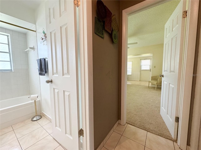 11619 Boynton Ln, New Port Richey, FL 34654 - bathroom featuring tile patterned flooring, shower / washtub combination, baseboards, and a textured ceiling