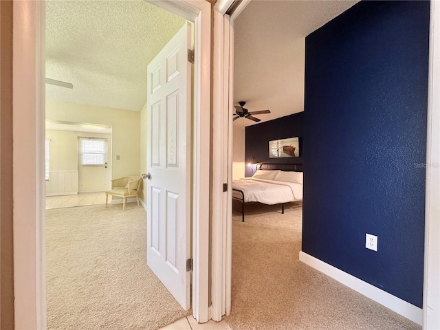 11619 Boynton Ln, New Port Richey, FL 34654 - hallway with carpet flooring, a textured ceiling, and baseboards