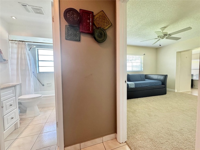 11619 Boynton Ln, New Port Richey, FL 34654 - hallway featuring light tile patterned flooring, a textured ceiling, and baseboards