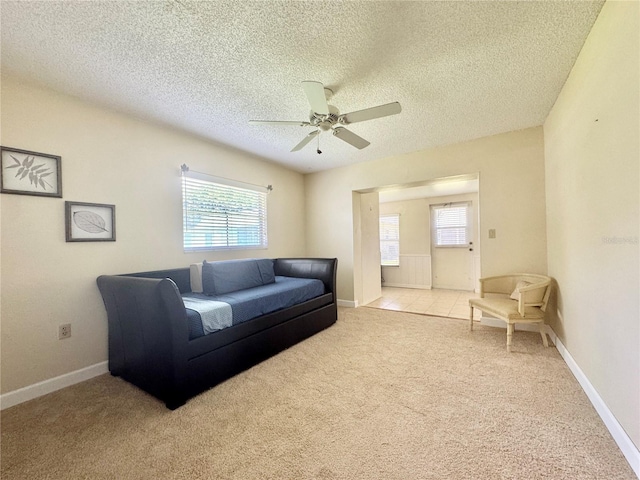 11619 Boynton Ln, New Port Richey, FL 34654 - living room featuring carpet flooring, a ceiling fan, a textured ceiling, and baseboards