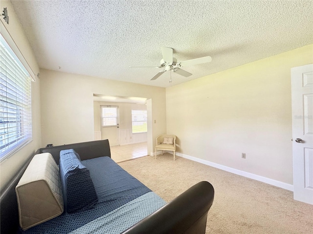 11619 Boynton Ln, New Port Richey, FL 34654 - bedroom with light colored carpet, a textured ceiling, ceiling fan, and baseboards