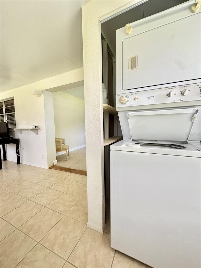 11619 Boynton Ln, New Port Richey, FL 34654 - laundry room with estacked washer and dryer and light tile patterned floors
