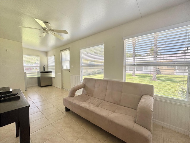 11619 Boynton Ln, New Port Richey, FL 34654 - living room with light tile patterned floors, a ceiling fan, and baseboards