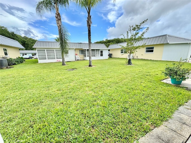 11619 Boynton Ln, New Port Richey, FL 34654 - view of grassy yard featuring central AC unit
