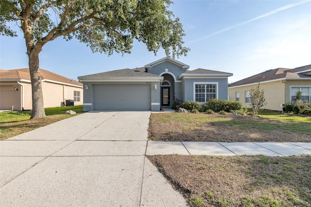 15159 Durango Cir, Brooksville, FL 34604 - ranch-style home with stucco siding, an attached garage, driveway, and a front yard
