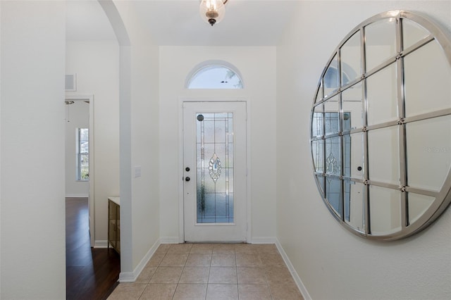 15159 Durango Cir, Brooksville, FL 34604 - entrance foyer with arched walkways, baseboards, and light tile patterned floors