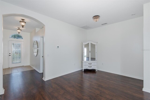 15159 Durango Cir, Brooksville, FL 34604 - empty room with wood finished floors, arched walkways, and baseboards