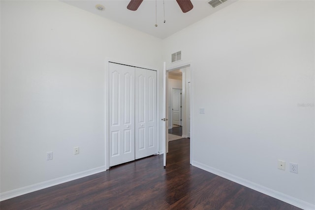 15159 Durango Cir, Brooksville, FL 34604 - unfurnished bedroom featuring dark wood-style floors, a closet, baseboards, and a ceiling fan