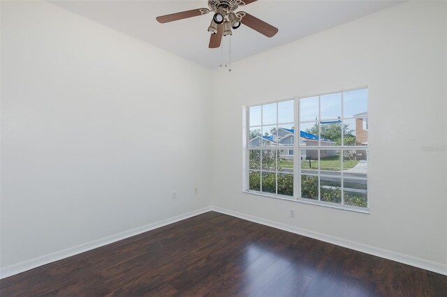 15159 Durango Cir, Brooksville, FL 34604 - empty room featuring dark wood-style flooring, baseboards, and ceiling fan