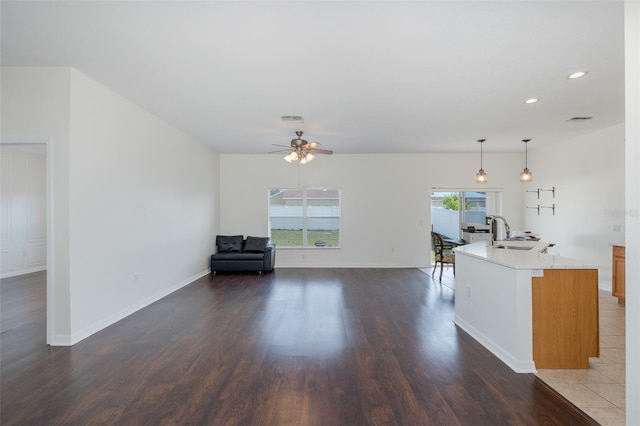15159 Durango Cir, Brooksville, FL 34604 - living area featuring dark wood-style flooring, a ceiling fan, recessed lighting, and baseboards