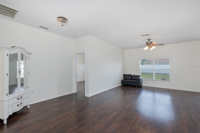 15159 Durango Cir, Brooksville, FL 34604 - unfurnished living room with dark wood-style flooring, ceiling fan, and baseboards
