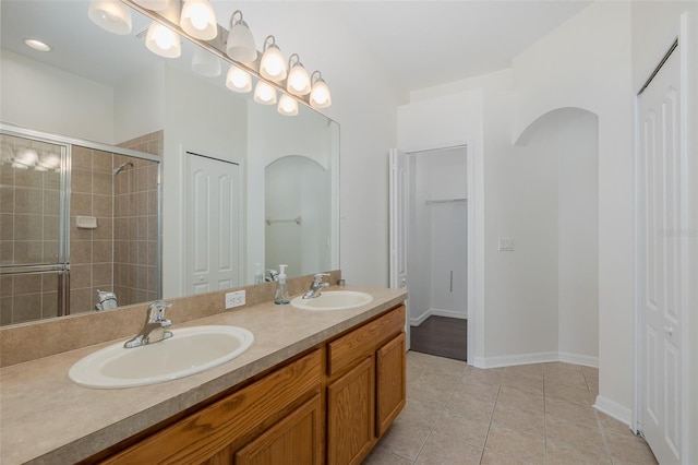 15159 Durango Cir, Brooksville, FL 34604 - full bathroom featuring a closet, a stall shower, tile patterned flooring, and double vanity