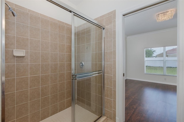 15159 Durango Cir, Brooksville, FL 34604 - bathroom featuring crown molding, a shower stall, wood finished floors, and baseboards