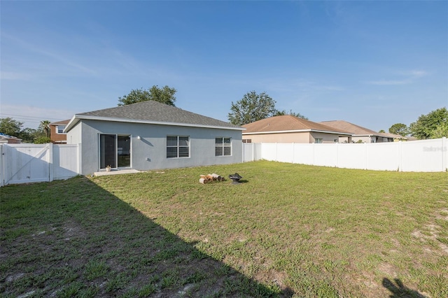 15159 Durango Cir, Brooksville, FL 34604 - back of house featuring stucco siding and a gate