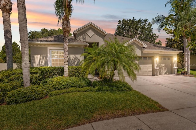3243 Stonegate Falls Dr, Land O Lakes, FL 34638 - view of front facade featuring stucco siding, driveway, and a garage