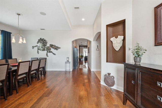 3243 Stonegate Falls Dr, Land O Lakes, FL 34638 - dining area with arched walkways, a chandelier, wood finished floors, baseboards, and recessed lighting