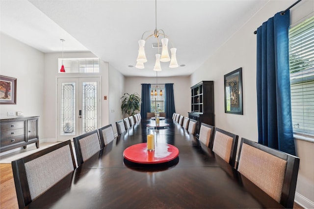 3243 Stonegate Falls Dr, Land O Lakes, FL 34638 - dining area featuring a chandelier, baseboards, wood finished floors, and french doors