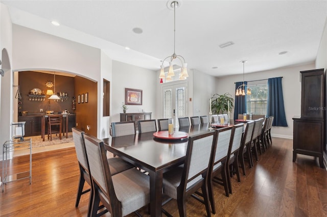 3243 Stonegate Falls Dr, Land O Lakes, FL 34638 - dining room featuring a chandelier, arched walkways, hardwood / wood-style floors, and recessed lighting