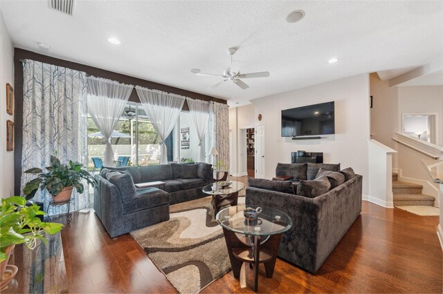3243 Stonegate Falls Dr, Land O Lakes, FL 34638 - living room with dark wood finished floors, ceiling fan, stairs, recessed lighting, and baseboards