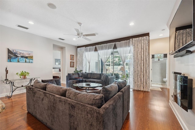 3243 Stonegate Falls Dr, Land O Lakes, FL 34638 - living room with a ceiling fan, dark wood finished floors, baseboards, recessed lighting, and a textured ceiling