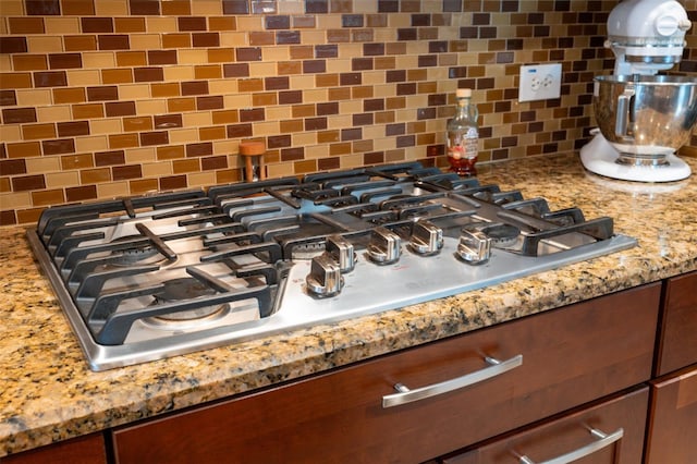 3243 Stonegate Falls Dr, Land O Lakes, FL 34638 - kitchen view of tasteful backsplash, stainless steel gas cooktop, and light stone counters