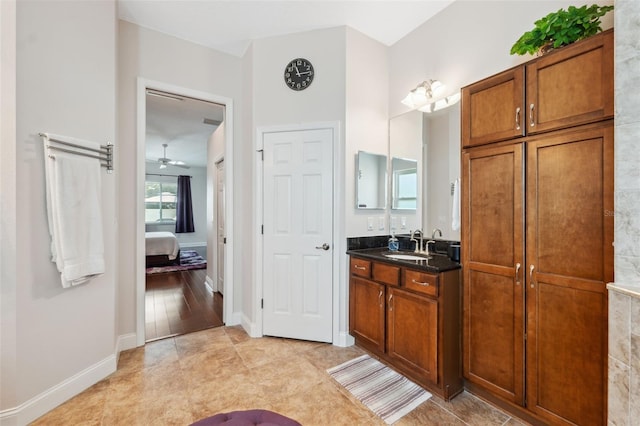 3243 Stonegate Falls Dr, Land O Lakes, FL 34638 - full bathroom featuring vanity, ceiling fan, baseboards, and ensuite bath