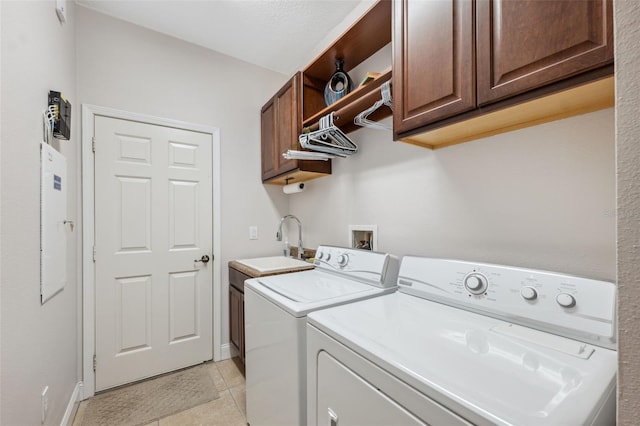 3243 Stonegate Falls Dr, Land O Lakes, FL 34638 - washroom with washer and clothes dryer, cabinet space, light tile patterned floors, and baseboards