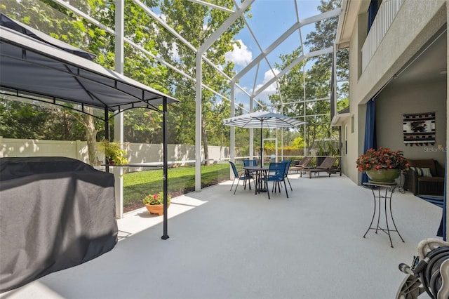 3243 Stonegate Falls Dr, Land O Lakes, FL 34638 - fenced backyard with outdoor dining space, a patio, glass enclosure, and a grill