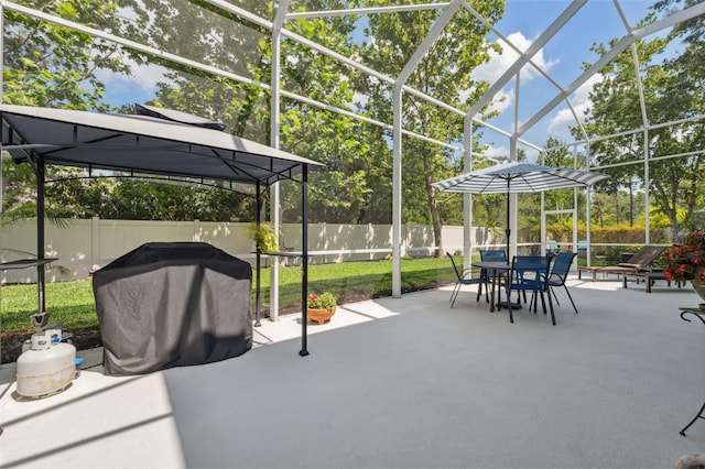 3243 Stonegate Falls Dr, Land O Lakes, FL 34638 - view of patio / terrace with outdoor dining area, a grill, and glass enclosure